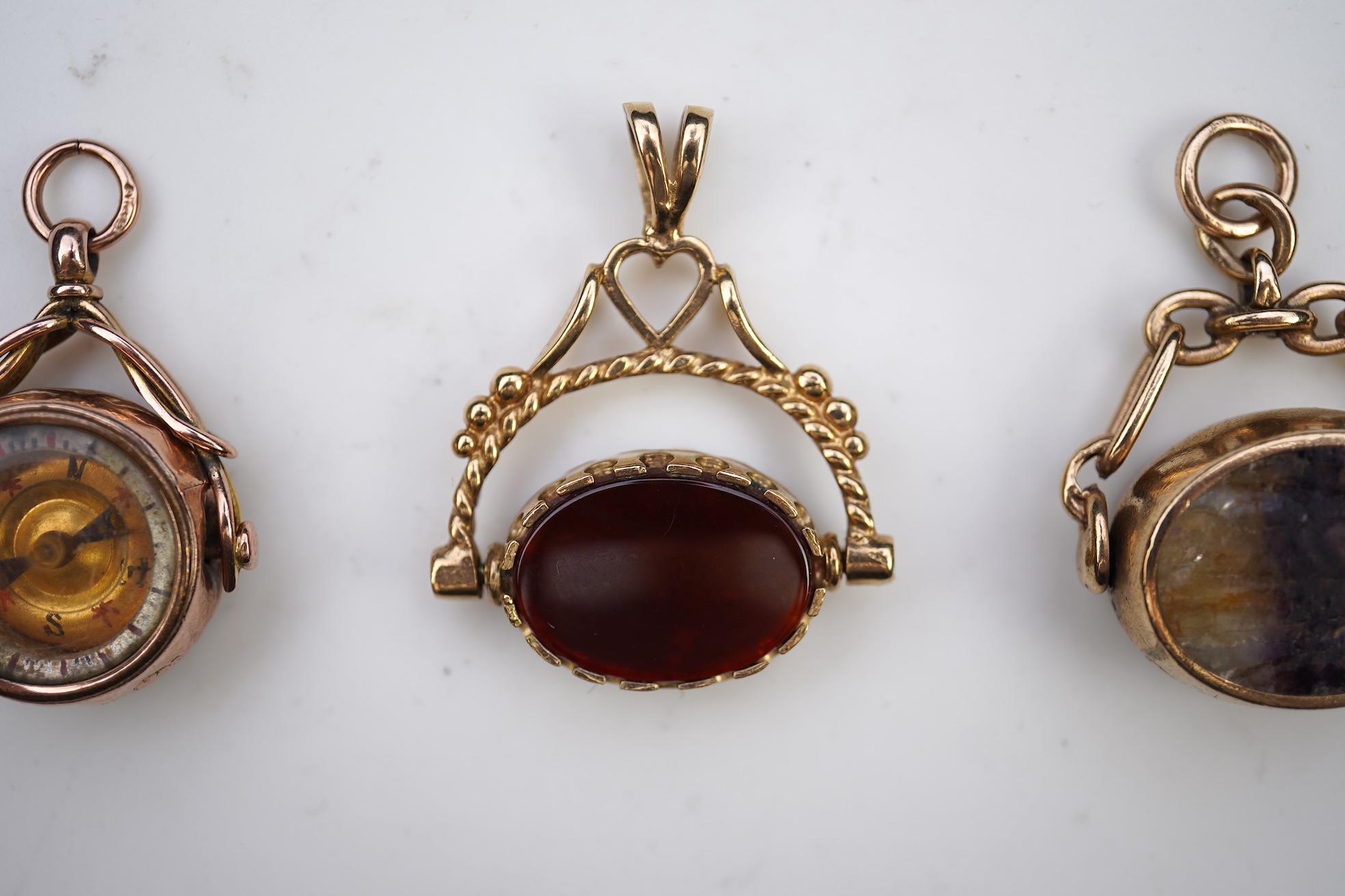 Three 9ct gold fob pendants